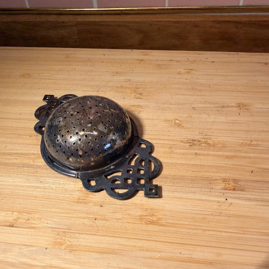 Vintage silver plated tea strainer with decorative handles